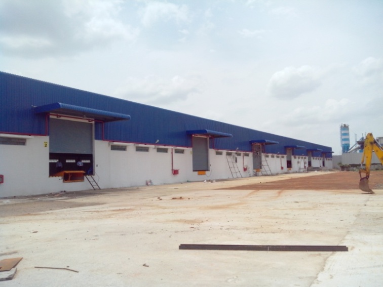 Industrial warehouse exterior with blue roof