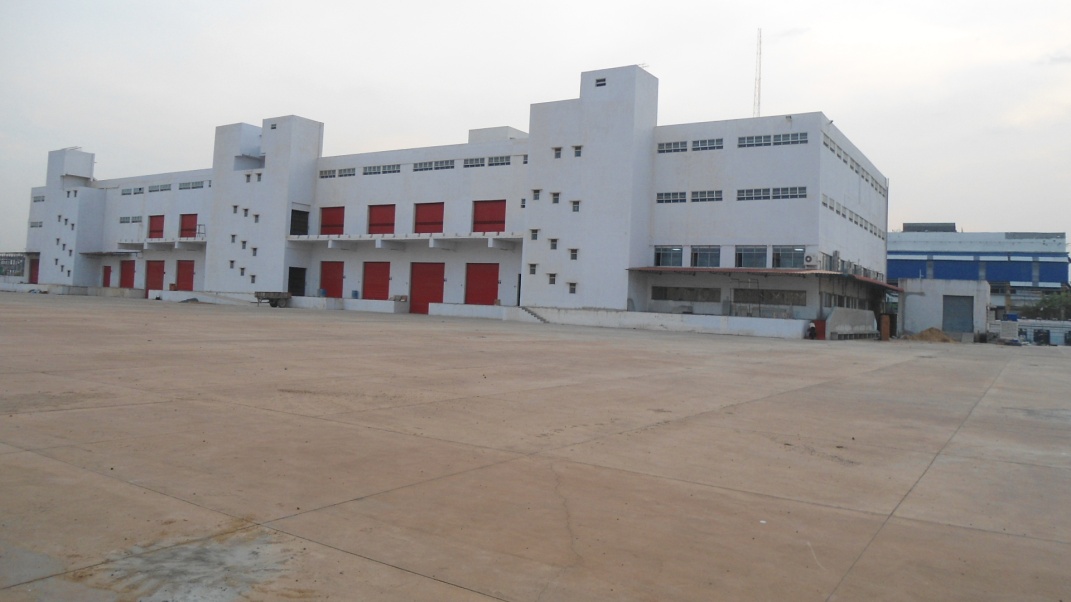 White industrial building with red accents